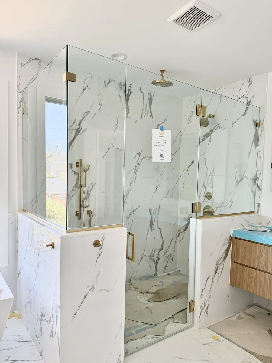 90 degree corner frameless glass shower enclosure, satin brass hardware, square pull