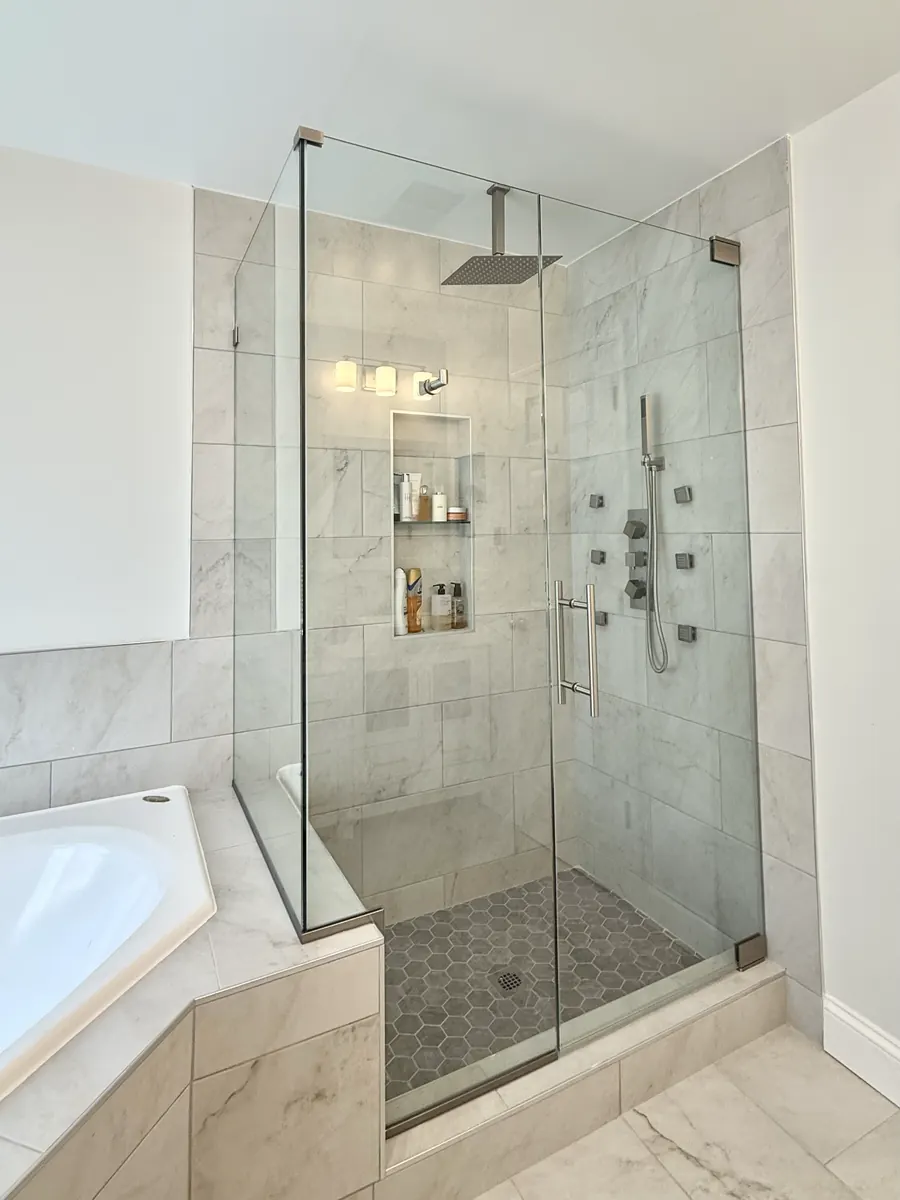 90 degree corner frameless glass shower enclosure, brushed nickel hardware, notch seat