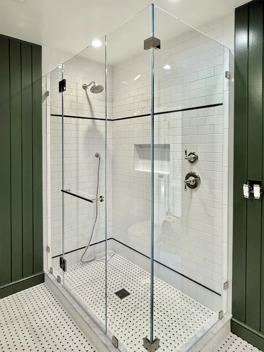 90 degree corner frameless glass shower enclosure, polished chrome hardware, towel bar
