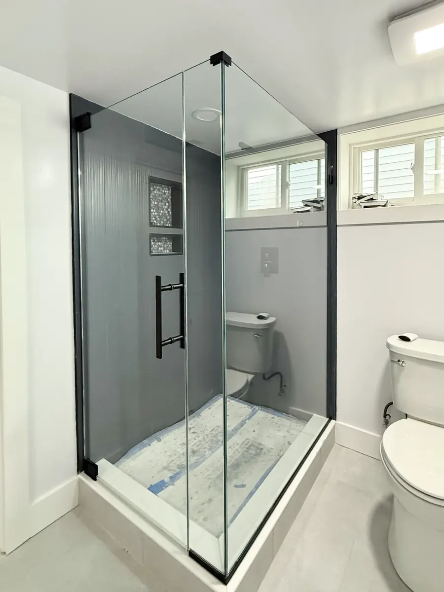 90 degree corner frameless glass shower enclosure, matte black hardware, ladder and clip