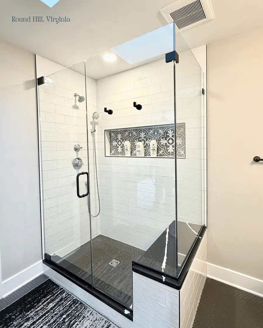 90 degree corner frameless glass shower enclosure, matte black hardware, notched panels