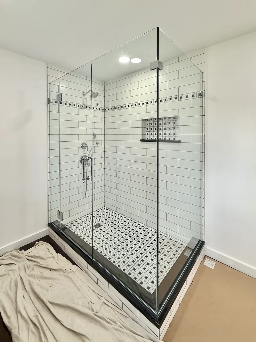 90 degree corner frameless glass shower enclosure, polished chrome hardware, checkered tile