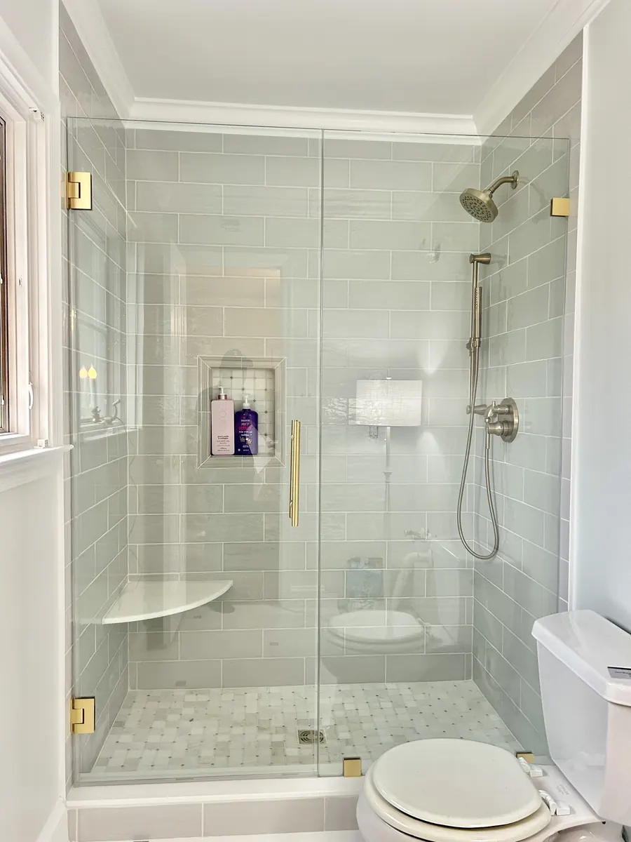 Door and panel frameless glass shower enclosure, satin brass hardware, Shower Door in Ijamsville Maryland