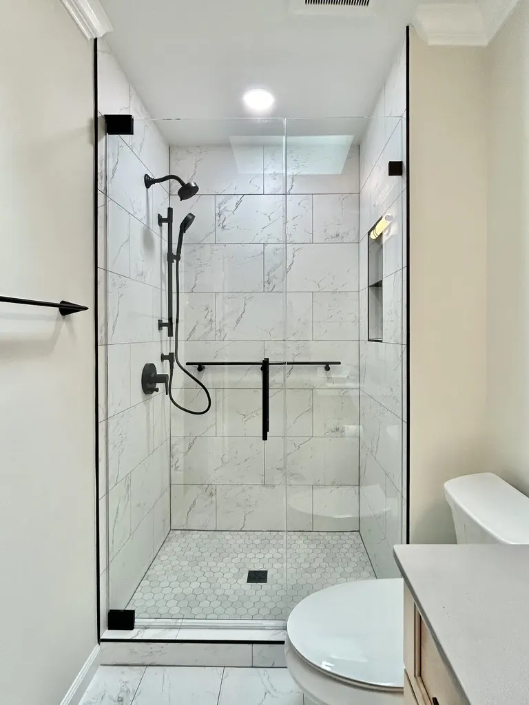 Door and panel frameless glass shower enclosure, matte black hardware, Frameless Door and Panel in Baltimore