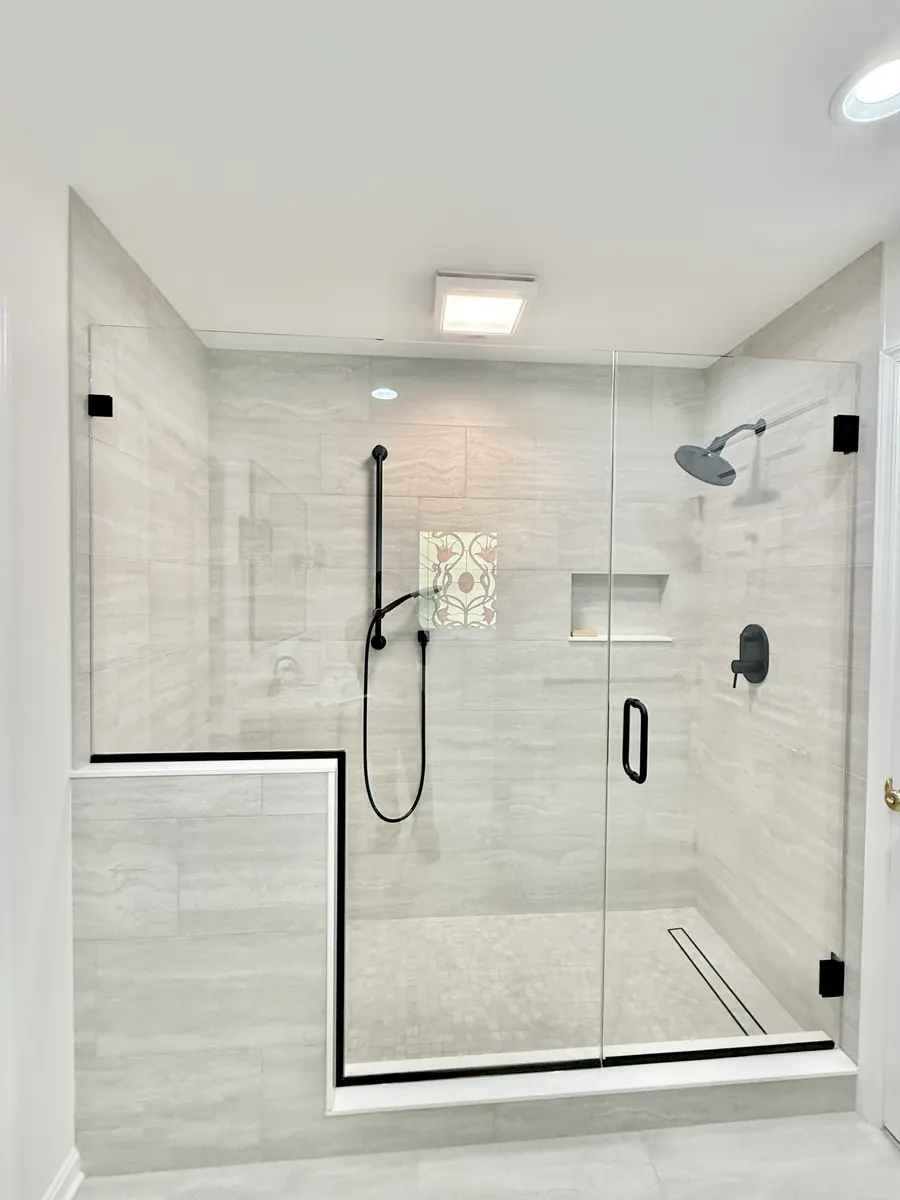 Door and panel frameless glass shower enclosure, matte black hardware