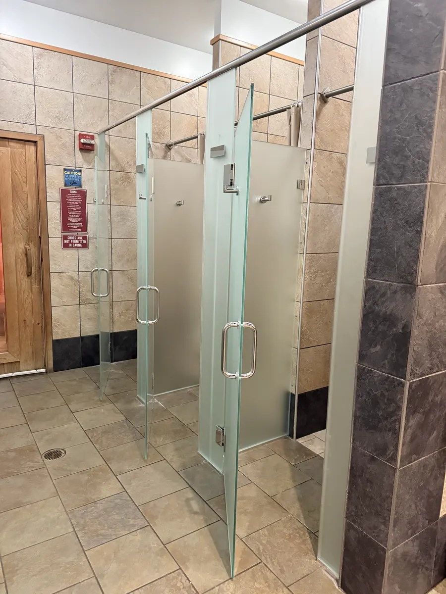Frameless glass shower enclosure, gym locker room