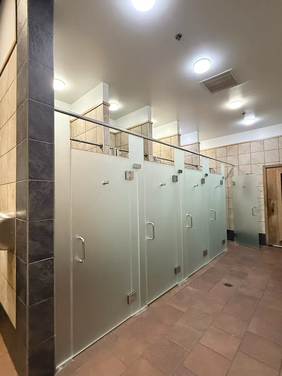 Frameless glass shower enclosure, gym locker room