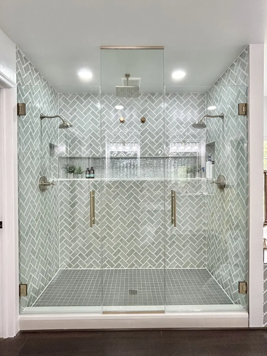 In-line panel frameless glass shower enclosure, brushed bronze hardware, double doors