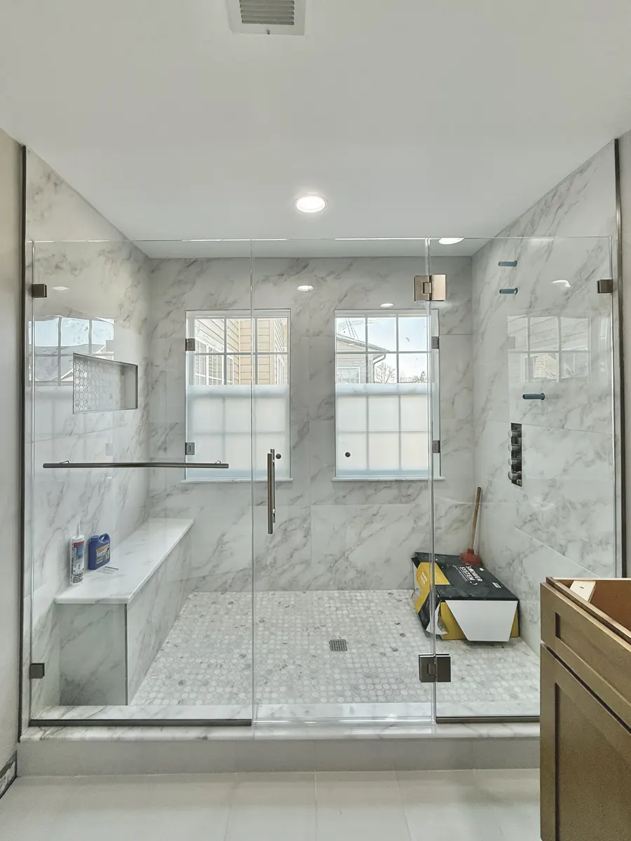 In-line panel frameless glass shower enclosure, brushed nickel hardware, towel bar