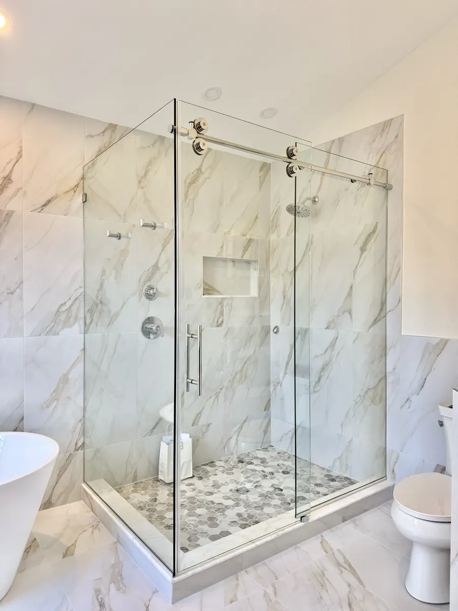 Titan series frameless sliding shower door, with a 90 degree return panel, brushed nickel hardware