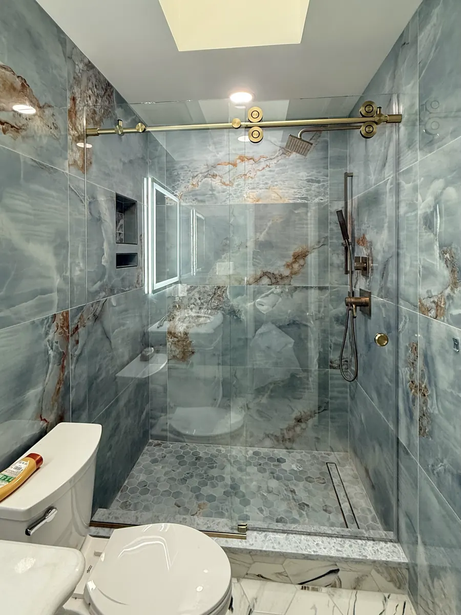 Titan series frameless sliding shower door, satin brass hardware
