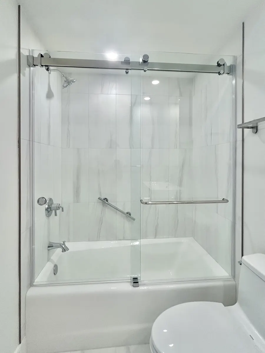 Titan Duo series frameless sliding shower door, over a tub, polished chrome hardware, Frameless Sliding Shower Door on Tub in Chevy Chase