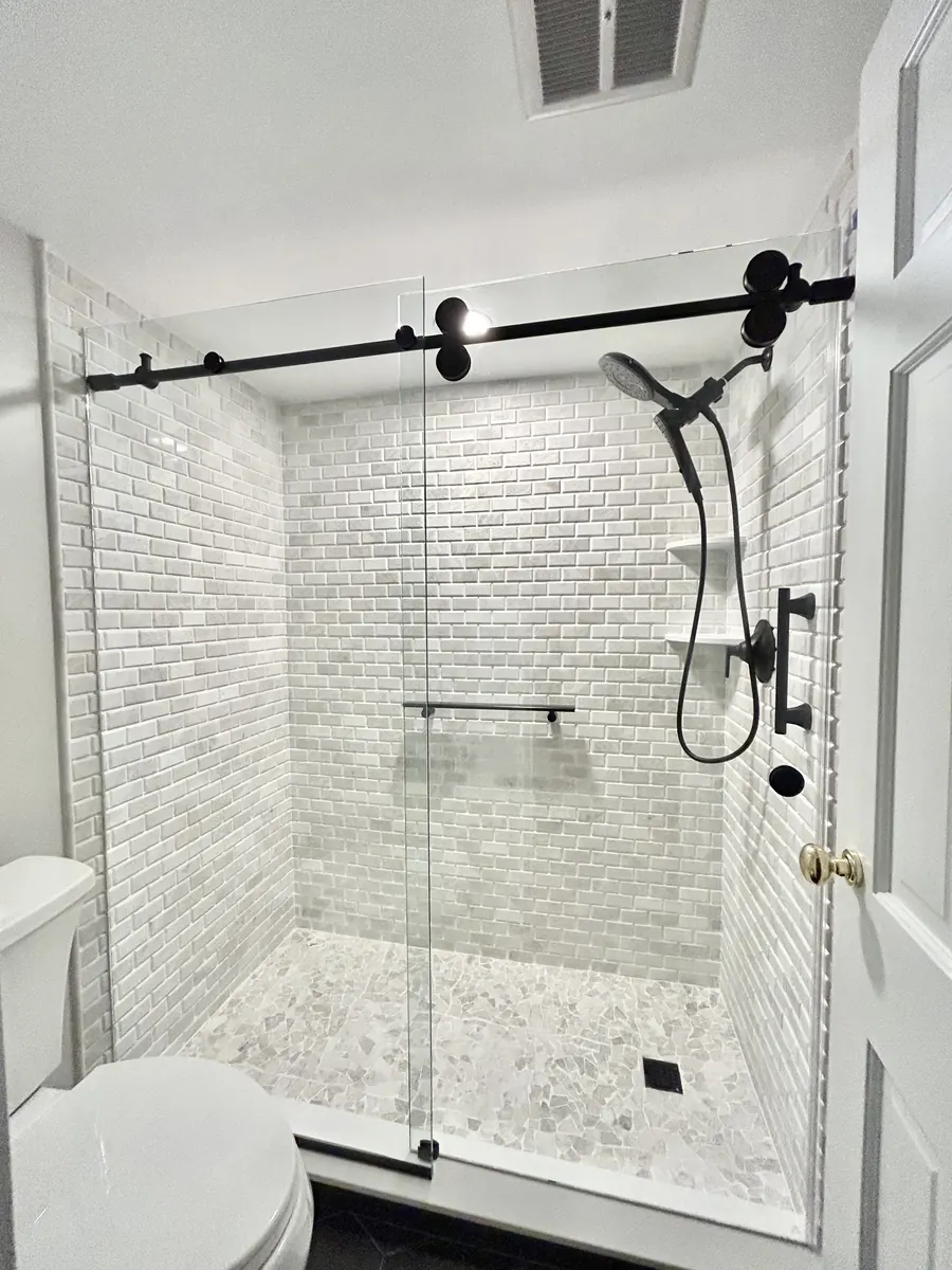 Titan series frameless sliding shower door, matte black hardware, Frameless Sliding Shower Door in Bethesda