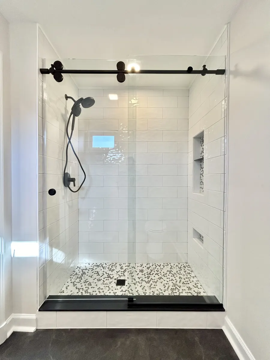 Titan series frameless sliding shower door, matte black hardware, Frameless Titan Slider in Glenelg