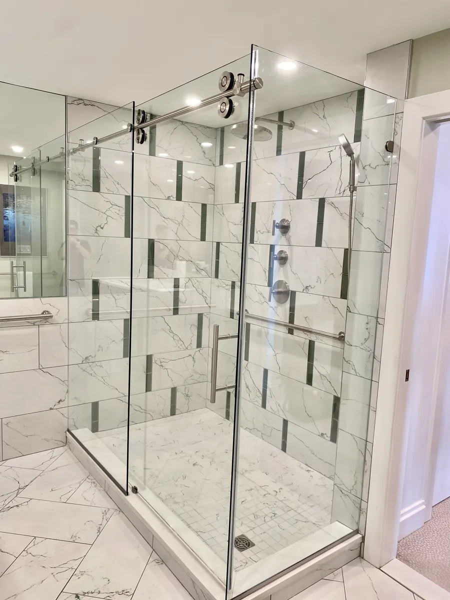 Titan series frameless sliding shower door, with a 90 degree return panel, nickel hardware