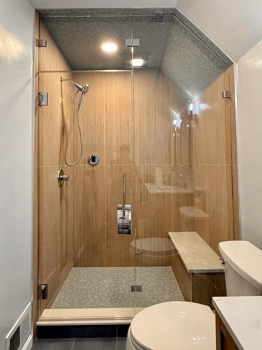 Steam shower enclosure, polished chrome hardware, transom, wood tile