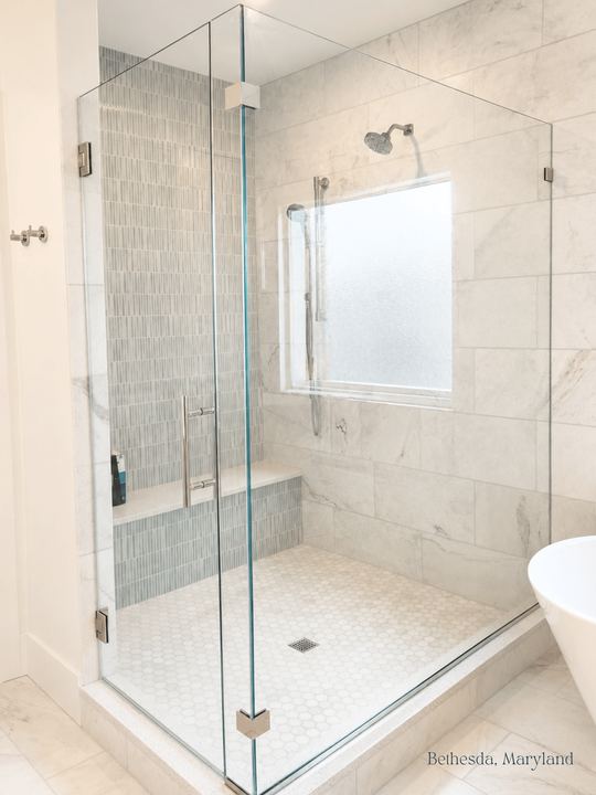 Frameless glass shower enclosure