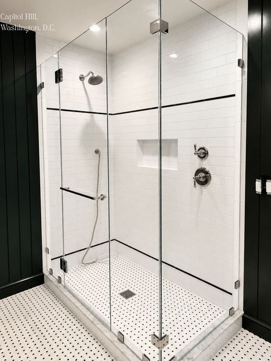 Frameless glass shower enclosure