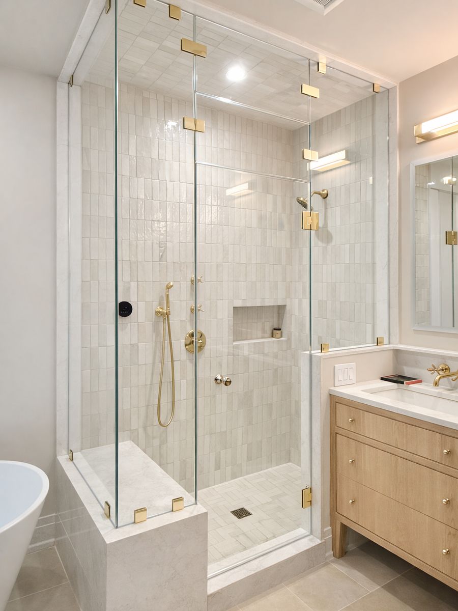 Corner steam shower enclosure with brass hardware